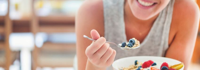 A person eating a bowl of cereal for their health.