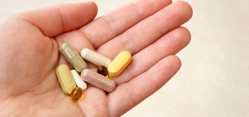 The person is holding supplements that Dr. David Sinclair recommends.