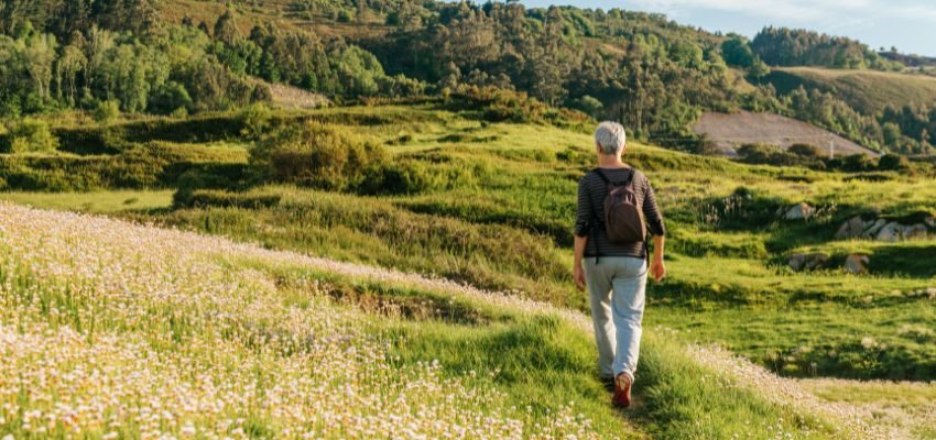 The older woman likes to walk to have a healthy body.