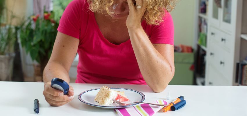 The woman checks her blood sugar level after eating sweets.